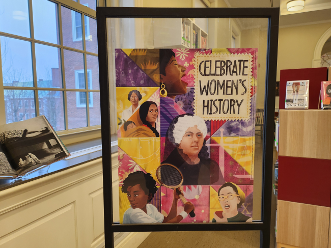 The sign depicts multiple notable women and the title "Celebrate Women's History" 